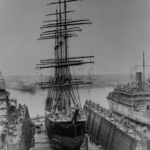 The barque "Pamir" shown in dry dock for cleaning and painting, seen beside a steamship. The Mariners' Museum P0001.011-01--PK0959